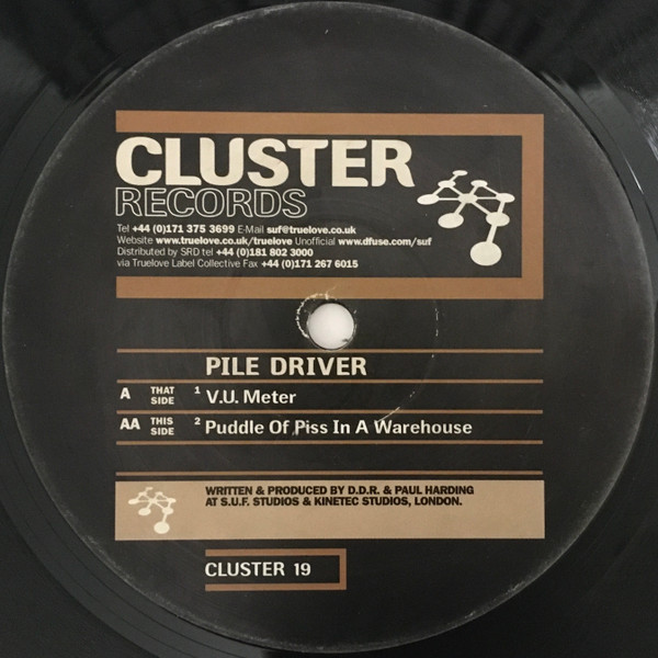 Pile Driver - V.U. Meter / Puddle Of Piss In A Warehouse | Cluster Records (CLUSTER 19) - main Pile Driver - V.U. Meter / Puddle Of Piss In A Warehouse | Cluster Records (CLUSTER 19) - main